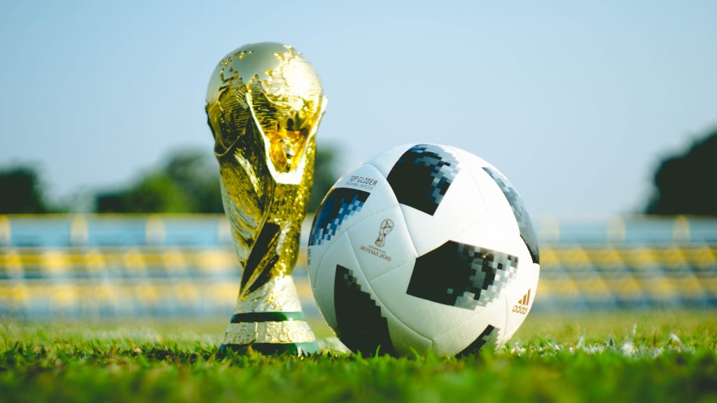 gold-colored FIFA World Cup Trophy and Football