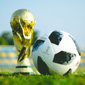 gold-colored FIFA World Cup Trophy and Football